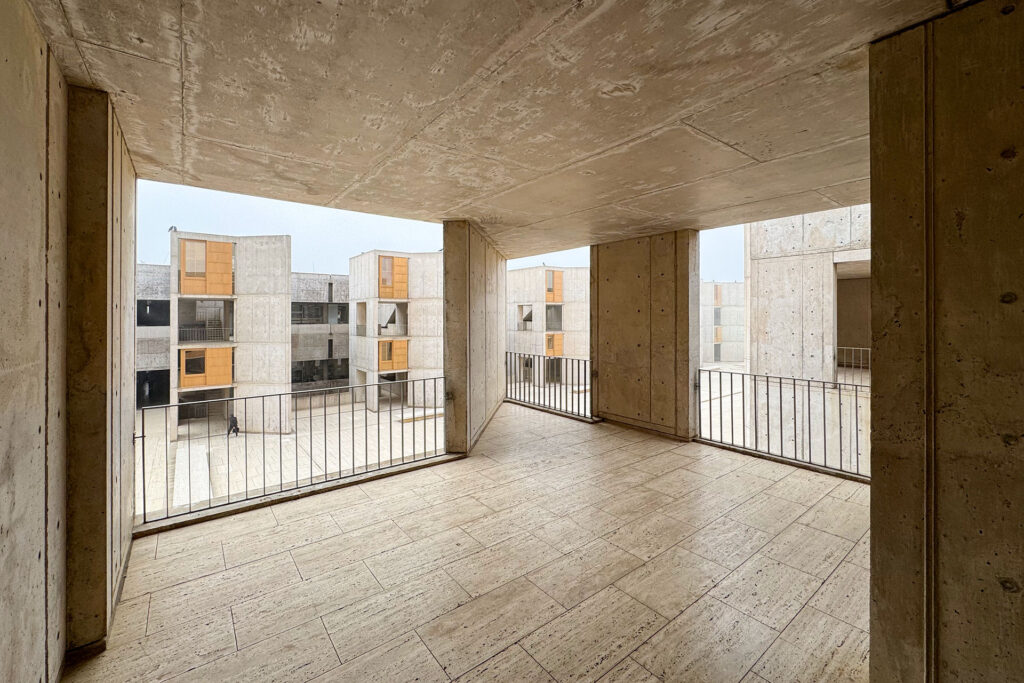 View looking out of a stair tower landing at the Salk Institute.