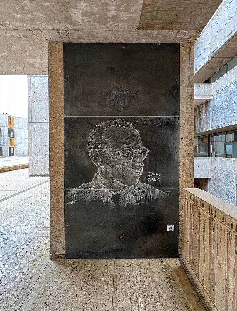 View of an exterior chalkboard with a drawing of Jonas Salk on it.